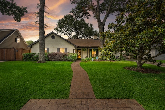 view of front of home with a lawn