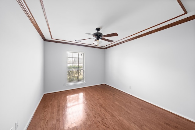 spare room featuring crown molding, ceiling fan, and hardwood / wood-style flooring