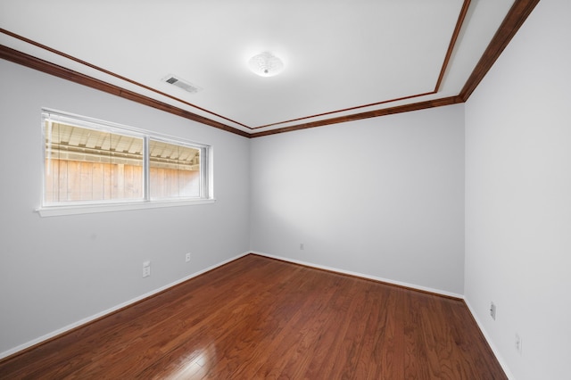 empty room featuring hardwood / wood-style floors and ornamental molding