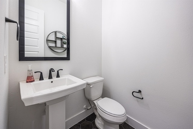 bathroom featuring toilet and tile patterned flooring