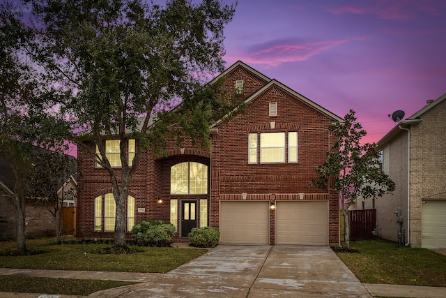 view of front of house featuring a garage and a yard