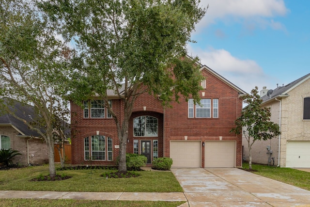 view of property with a front yard and a garage