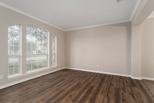 spare room with ornamental molding, plenty of natural light, and dark hardwood / wood-style floors