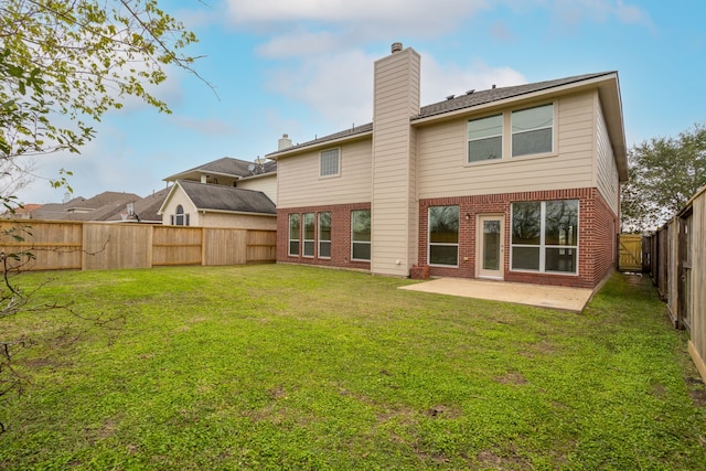 back of property featuring a yard and a patio area