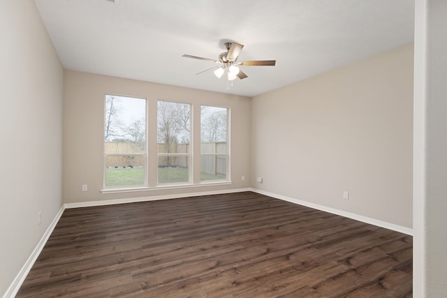 empty room featuring dark hardwood / wood-style flooring and ceiling fan