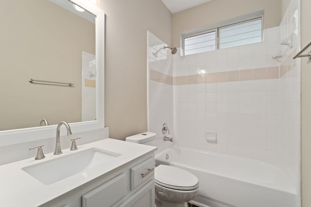 full bathroom featuring toilet, tiled shower / bath, and vanity