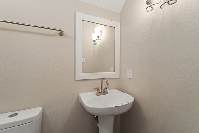 bathroom featuring sink and toilet