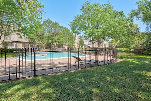 view of pool featuring a patio area and a yard