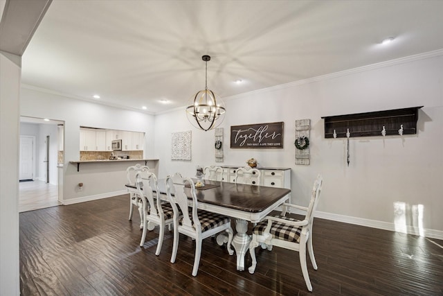 dining area featuring dark hardwood / wood-style flooring, an inviting chandelier, and ornamental molding