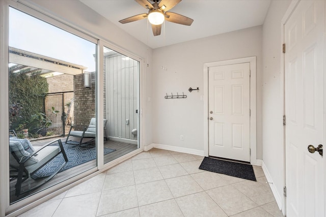 doorway featuring light tile patterned floors, ceiling fan, and a healthy amount of sunlight