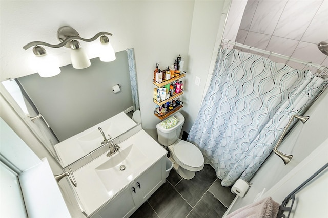 bathroom featuring toilet, tile patterned floors, and vanity