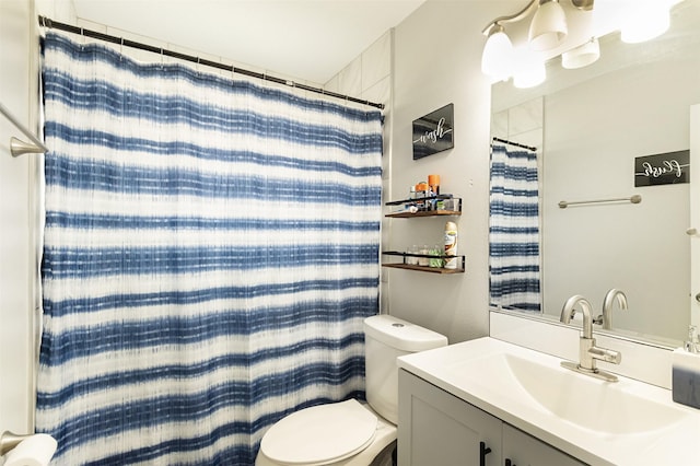 bathroom with vanity, curtained shower, and toilet