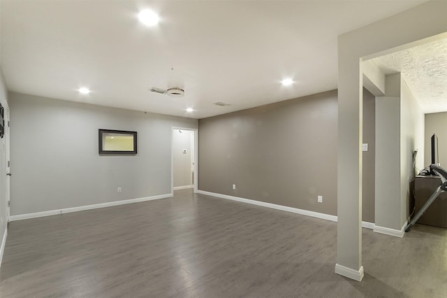 unfurnished room with dark wood-type flooring