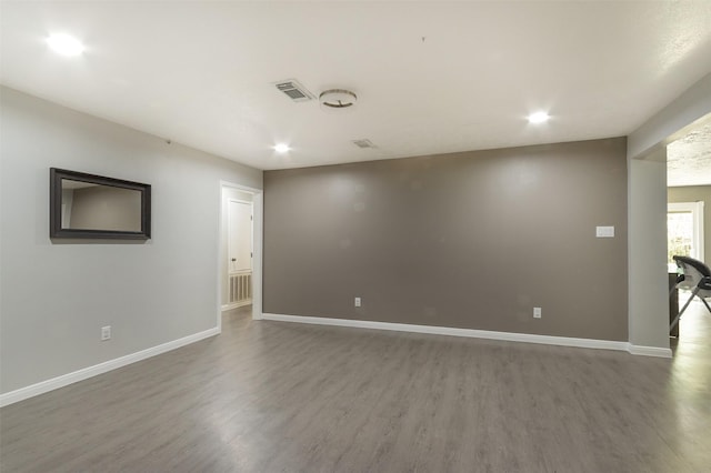 spare room with dark hardwood / wood-style flooring