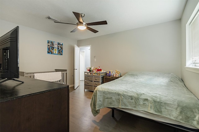 bedroom with hardwood / wood-style flooring and ceiling fan