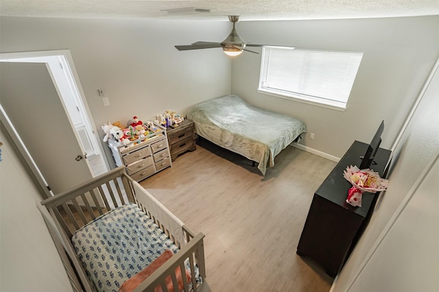 bedroom featuring hardwood / wood-style floors and ceiling fan