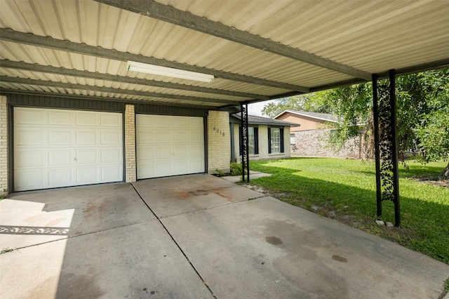 garage featuring a lawn and a carport