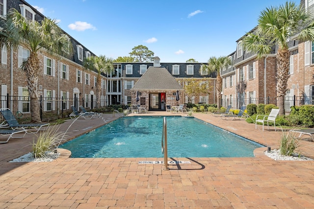 view of swimming pool with a patio and pool water feature