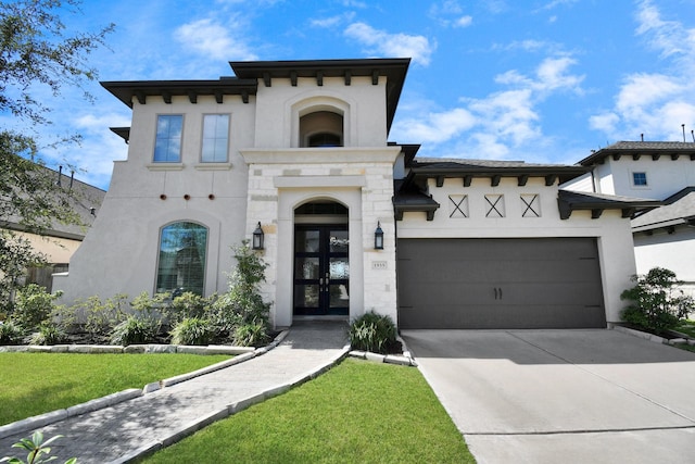 view of front of house with french doors, a front lawn, and a garage