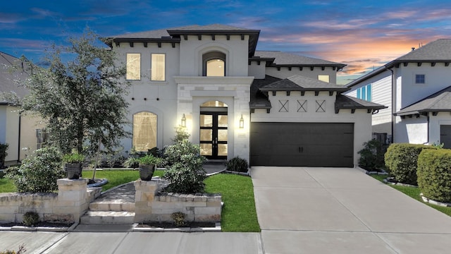 view of front of property featuring french doors and a garage