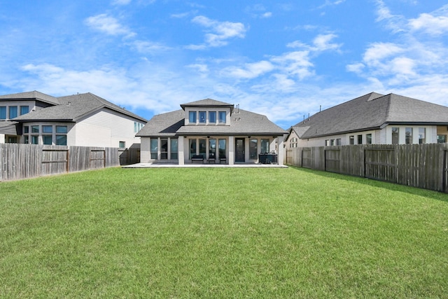 rear view of house featuring a lawn and a patio area