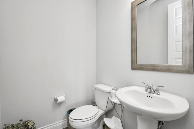 bathroom featuring toilet and sink