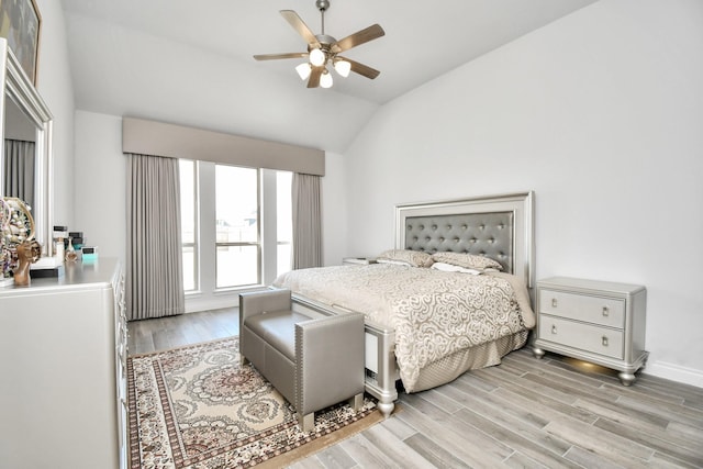 bedroom featuring lofted ceiling, ceiling fan, and light wood-type flooring