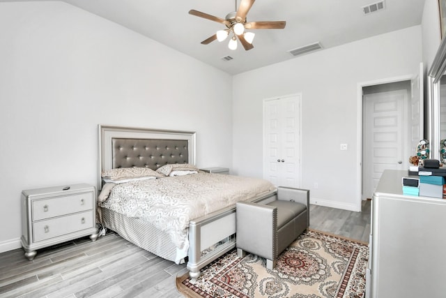 bedroom with ceiling fan, light hardwood / wood-style flooring, and a closet