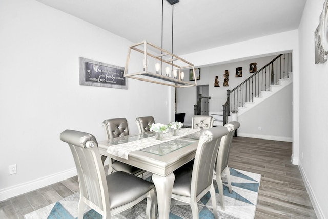 dining room with hardwood / wood-style flooring and a chandelier