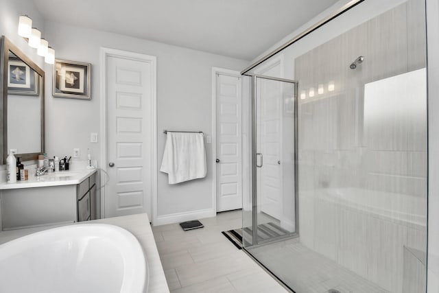 bathroom with tile patterned flooring, plus walk in shower, and vanity