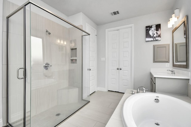 bathroom featuring independent shower and bath and vanity