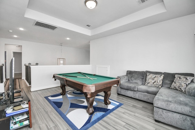 playroom featuring pool table, a raised ceiling, and hardwood / wood-style floors