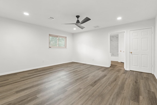 unfurnished room with visible vents, wood finished floors, and recessed lighting