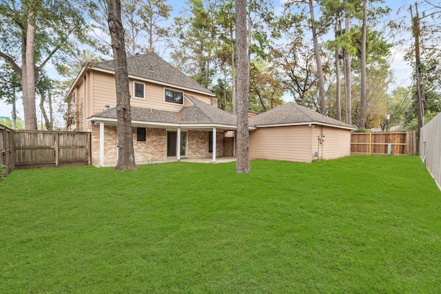 back of property featuring a patio area, a fenced backyard, a lawn, and brick siding