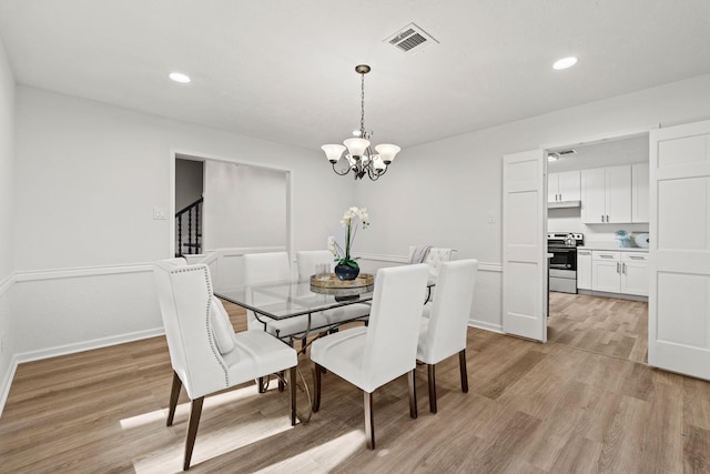 dining room with baseboards, light wood finished floors, recessed lighting, and an inviting chandelier