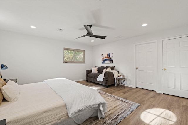 bedroom with wood finished floors, visible vents, and recessed lighting