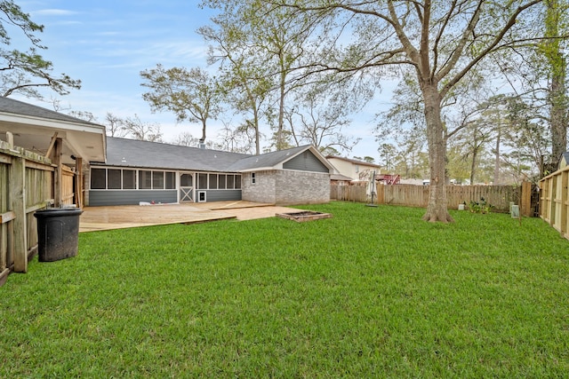 view of yard with a sunroom and a patio