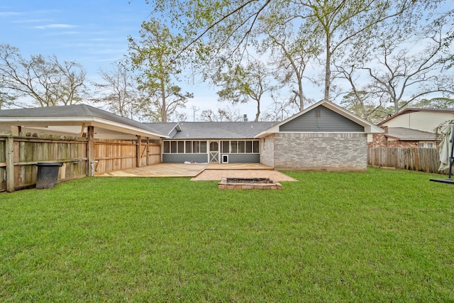 rear view of property featuring a yard and a patio area