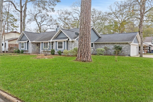 single story home with a front yard and a garage