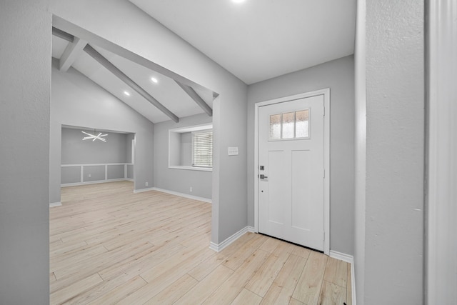 entrance foyer with vaulted ceiling with beams and light hardwood / wood-style flooring