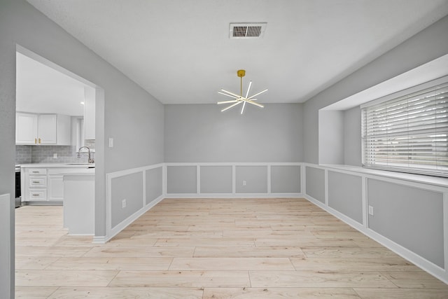 interior space featuring sink and a notable chandelier