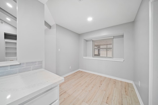 unfurnished room with light wood-type flooring