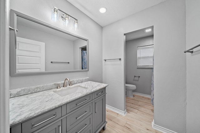 bathroom featuring vanity, toilet, and a textured ceiling