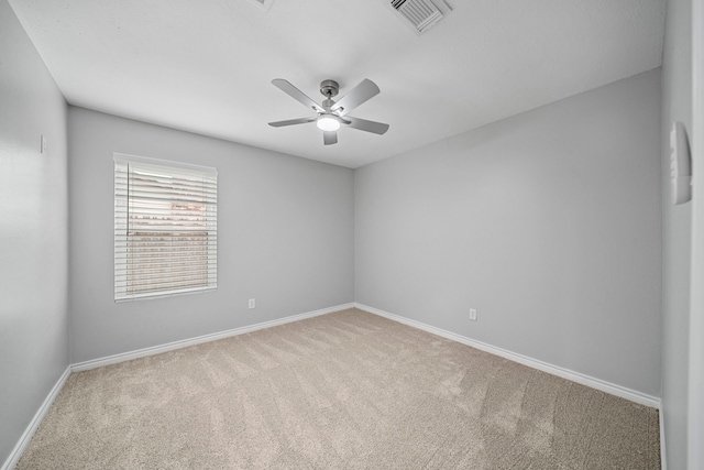 empty room featuring ceiling fan and light colored carpet