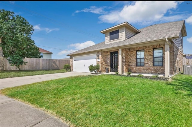 view of front facade with a front yard, central air condition unit, and a garage