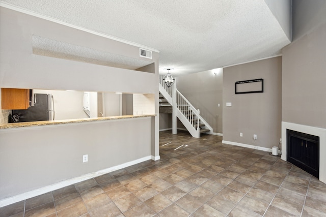 unfurnished living room featuring a textured ceiling