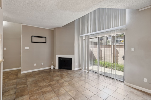 unfurnished living room with a textured ceiling and tile patterned floors