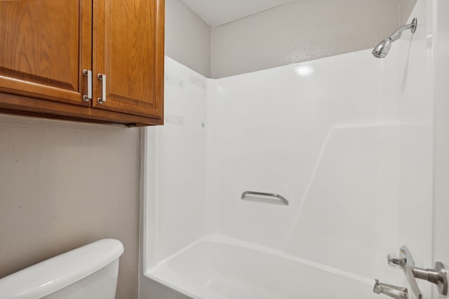 bathroom with toilet and shower / washtub combination