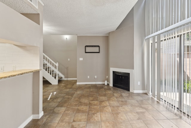 unfurnished living room featuring a textured ceiling