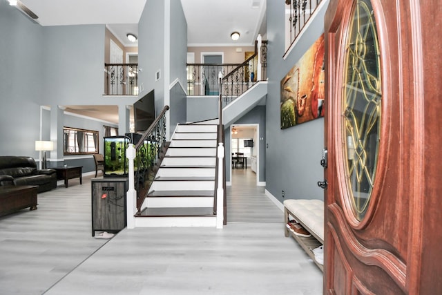 interior space featuring a high ceiling and light wood-type flooring